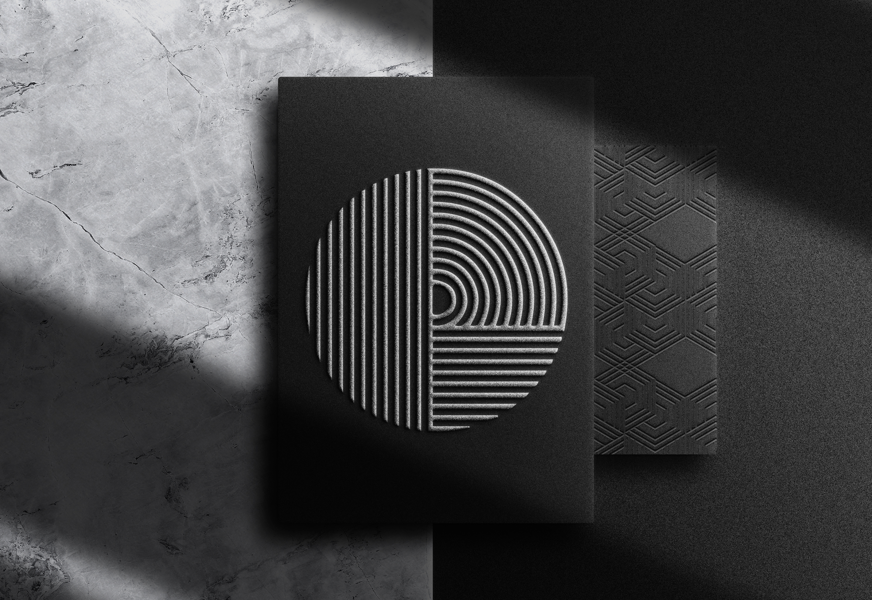 Elegant black embossed brand pattern featuring geometric circular and linear designs on textured paper — symbolising precision, depth, and structure in modern brand system and identity design.