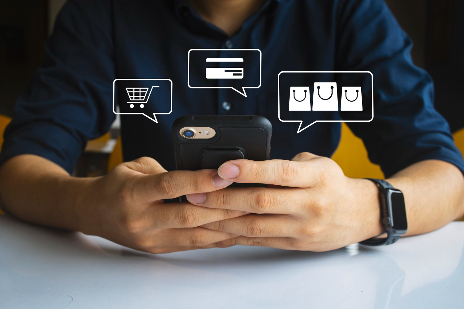 Person using a smartphone with digital shopping icons for cart, payment, and bags floating above the screen